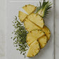 Sliced pineapple on a white plate with text about zero sugar and pure performance.