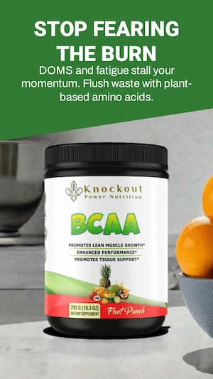 Knockout Power Nutrition BCAA supplement container on a kitchen counter with oranges in the background.